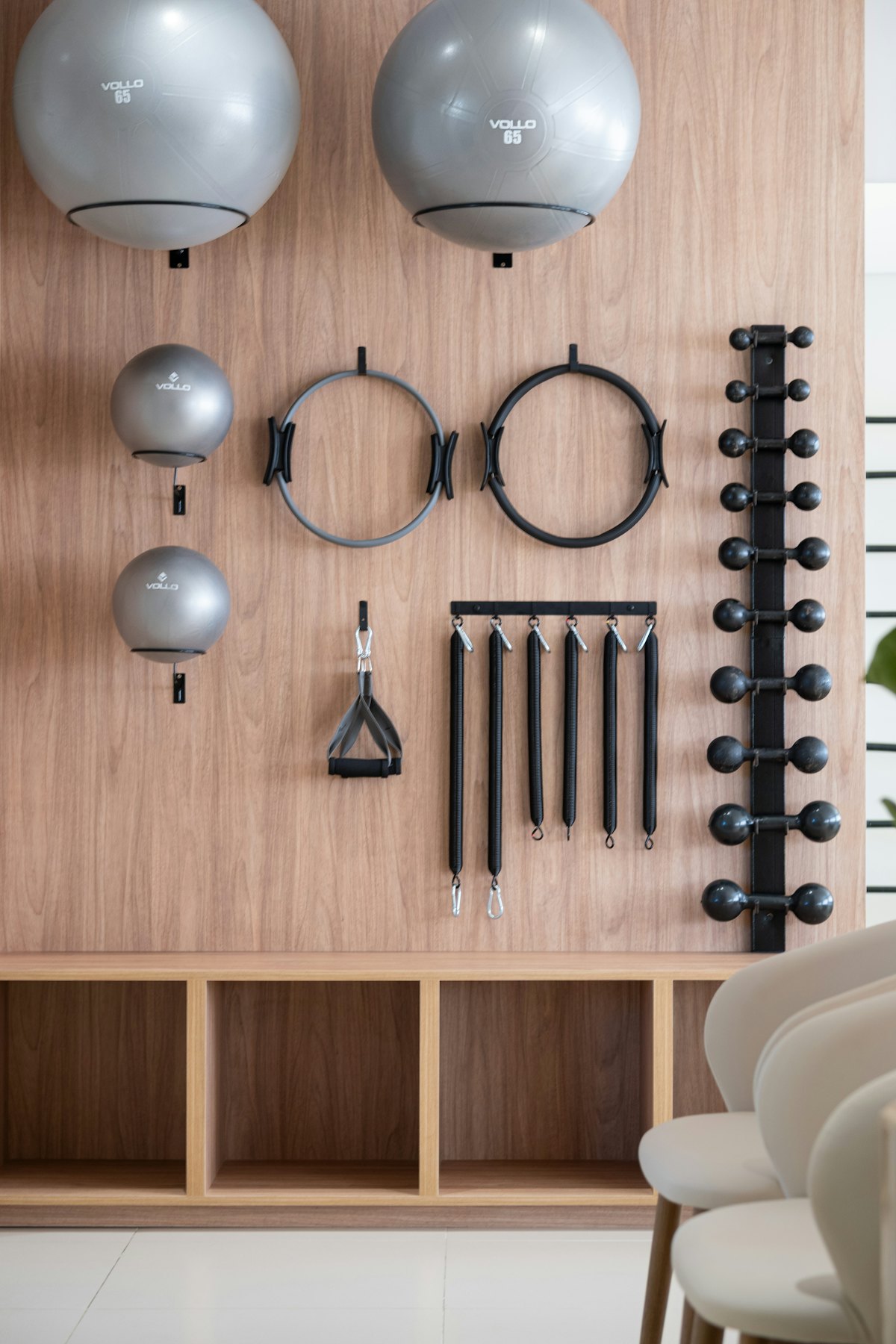Props and resistance bands arranged on a wooden studio wall.